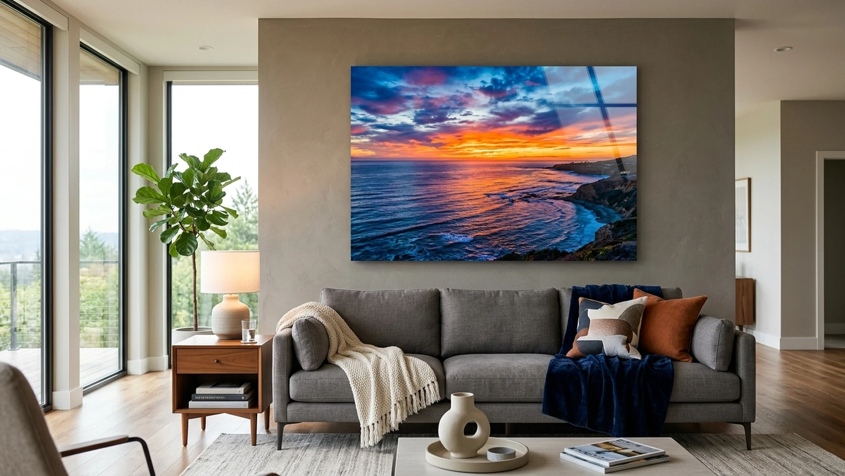 Vivid ocean sunset on an acrylic print above a grey sofa in a modern living room