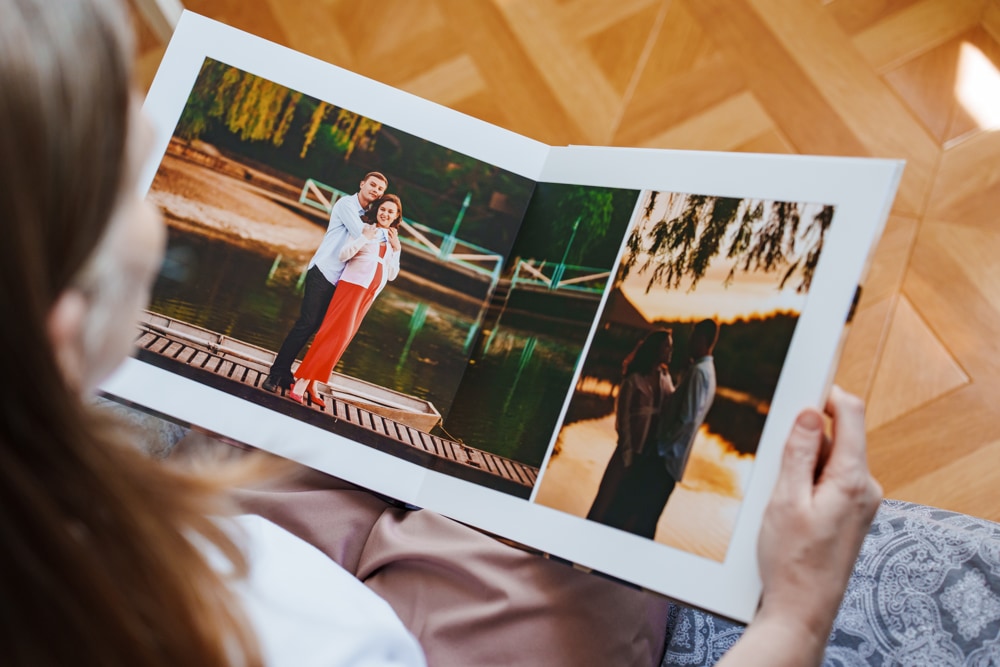 Couple building a shared memory display with photo prints and keepsakes