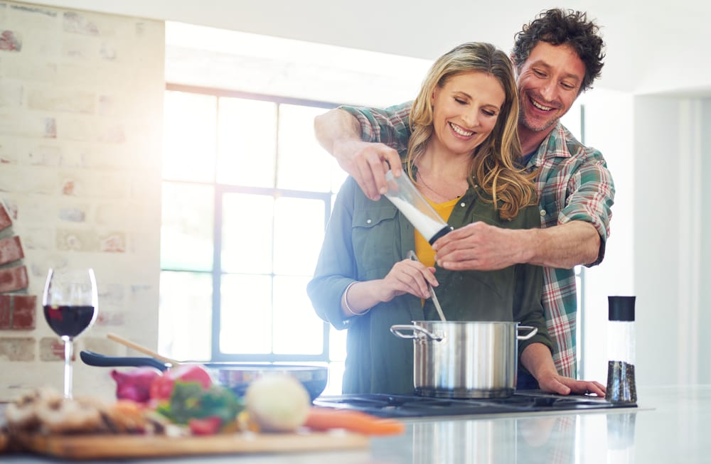 Couple cooking together to celebrate wedding anniversary