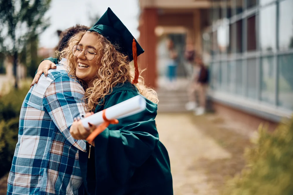 Father and daughter embracing at graduation, showing love and pride