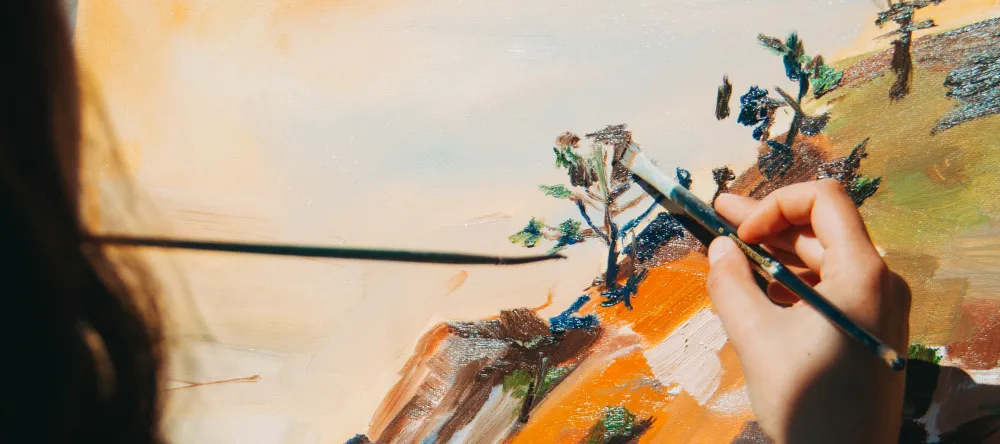 What are canvas paintings. Person painting on a canvas. 