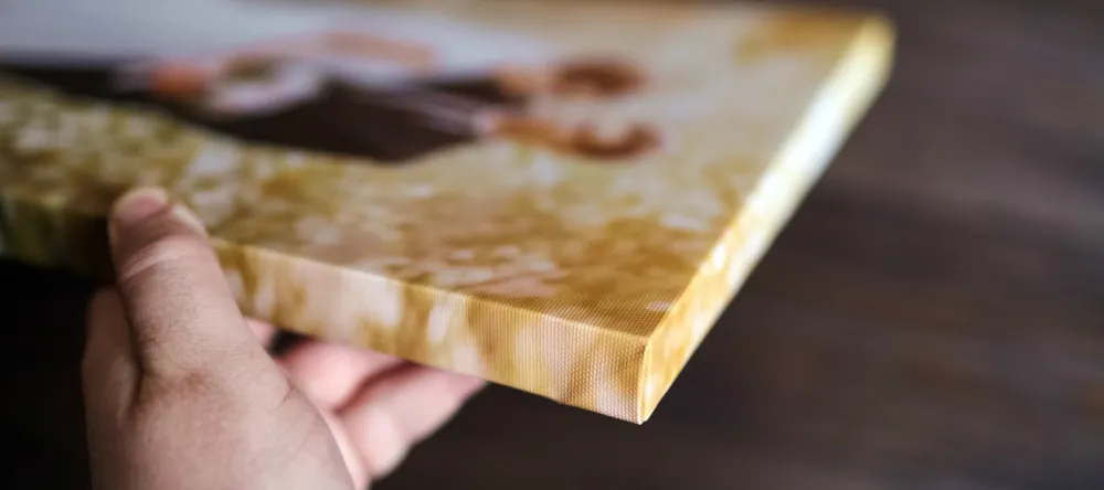 What are canvas paintings. Person holding a photo canvas print. 