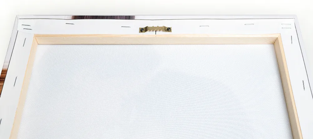 How to hang canvas prints. Sawtooth hanger attached to top edge of canvas frame.