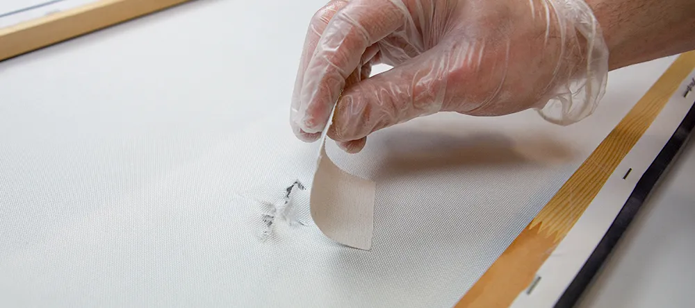 How to fix a ripped canvas. Applying patch to tear on canvas.