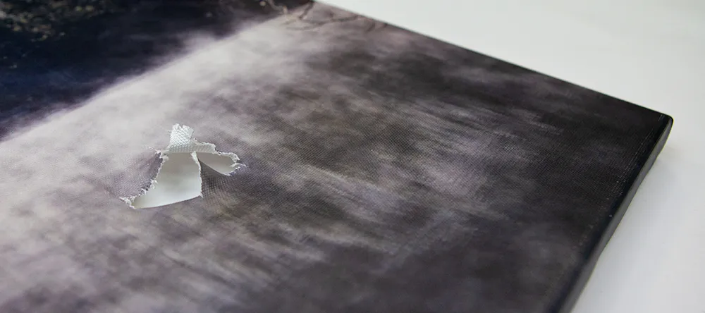 How to fix a ripped canvas. Close up of tear on canvas. 