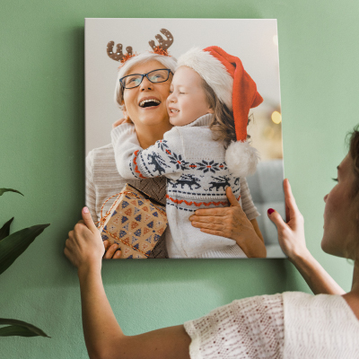 Christmas Canvas Ideas 2025: Woman hanging canvas print