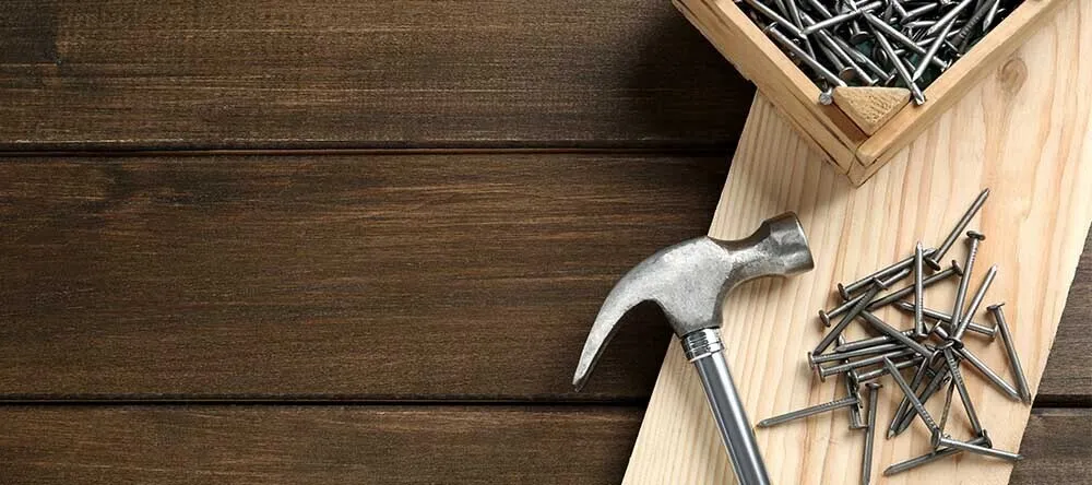 How to Hang Pictures Without Nails. Young Woman Hanging Wall Art.