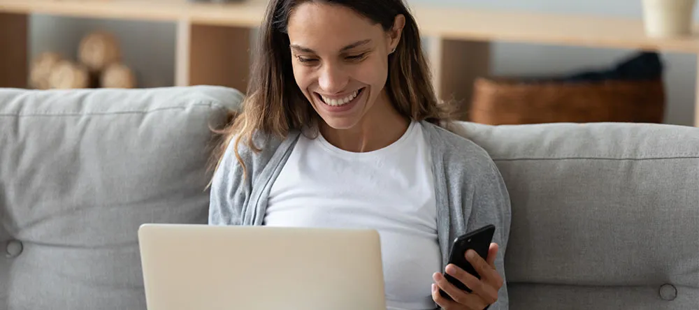 How to Order Canvas Prints. Young woman ordering canvas prints online on her laptop.