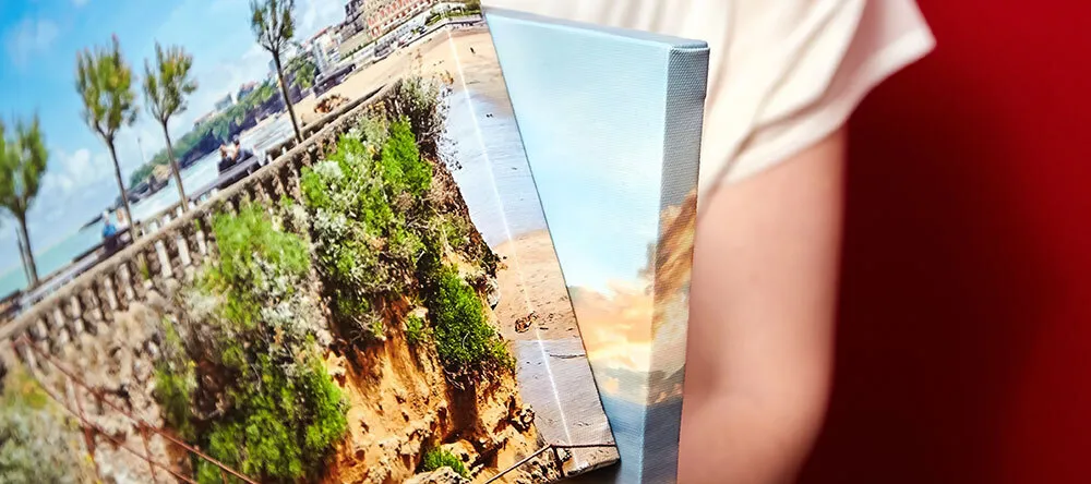 How to Order Canvas Prints. Person holding multiple photo canvas prints. 