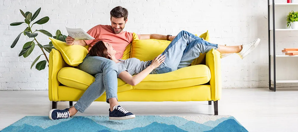 Custom Rugs with Logo or Picture. Young couple resting on sofa. 