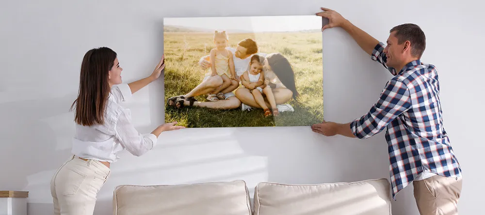 What Is an Acrylic Print. Couple mounting their acrylic print in living room.