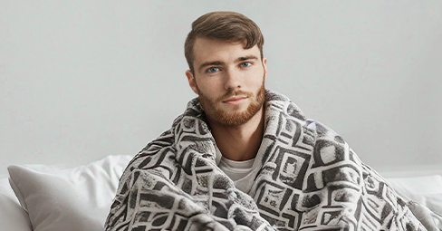 Customized blankets for boyfriends: a couple snuggling in a blanket