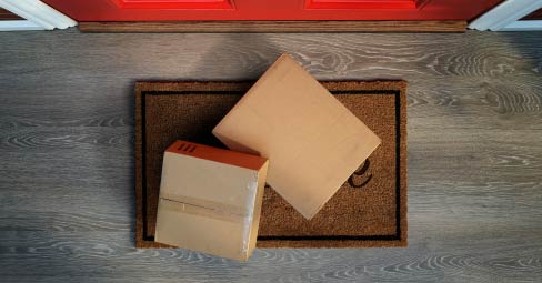 How Fast Exactly are Fast Delivery Canvas Prints? Person collecting parcel left on dormat.