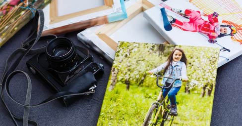 How to Order Canvas Prints. Young woman ordering canvas prints online on her laptop.