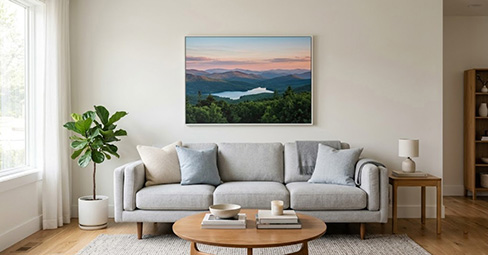 Canvas wall art sized to two-thirds of sofa width demonstrating correct proportions above a couch.