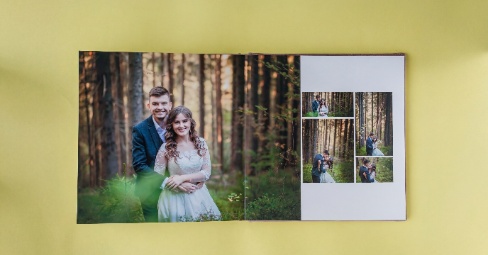 A beautiful wedding photo book lying open on a table showing wedding memories.