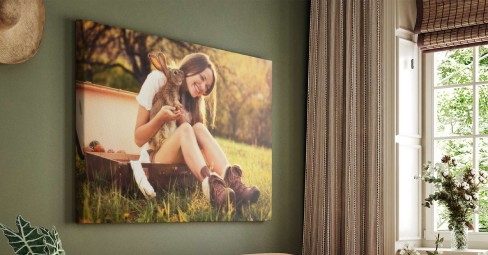 person hanging up large photo print on wall