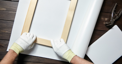 What's a gallery wrap? Wooden framework with canvas and tools next to it.