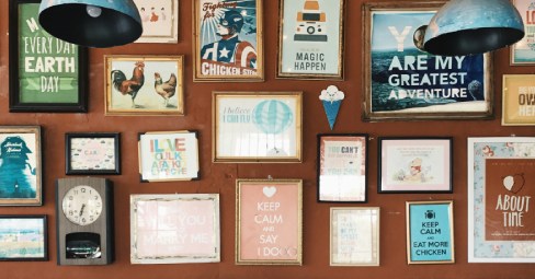 printed posters arranged on a wall