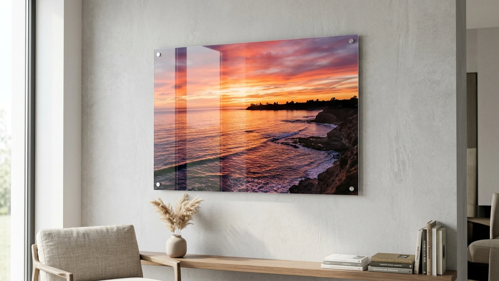 Coastal sunset photo on a glossy acrylic panel mounted above a living-room console